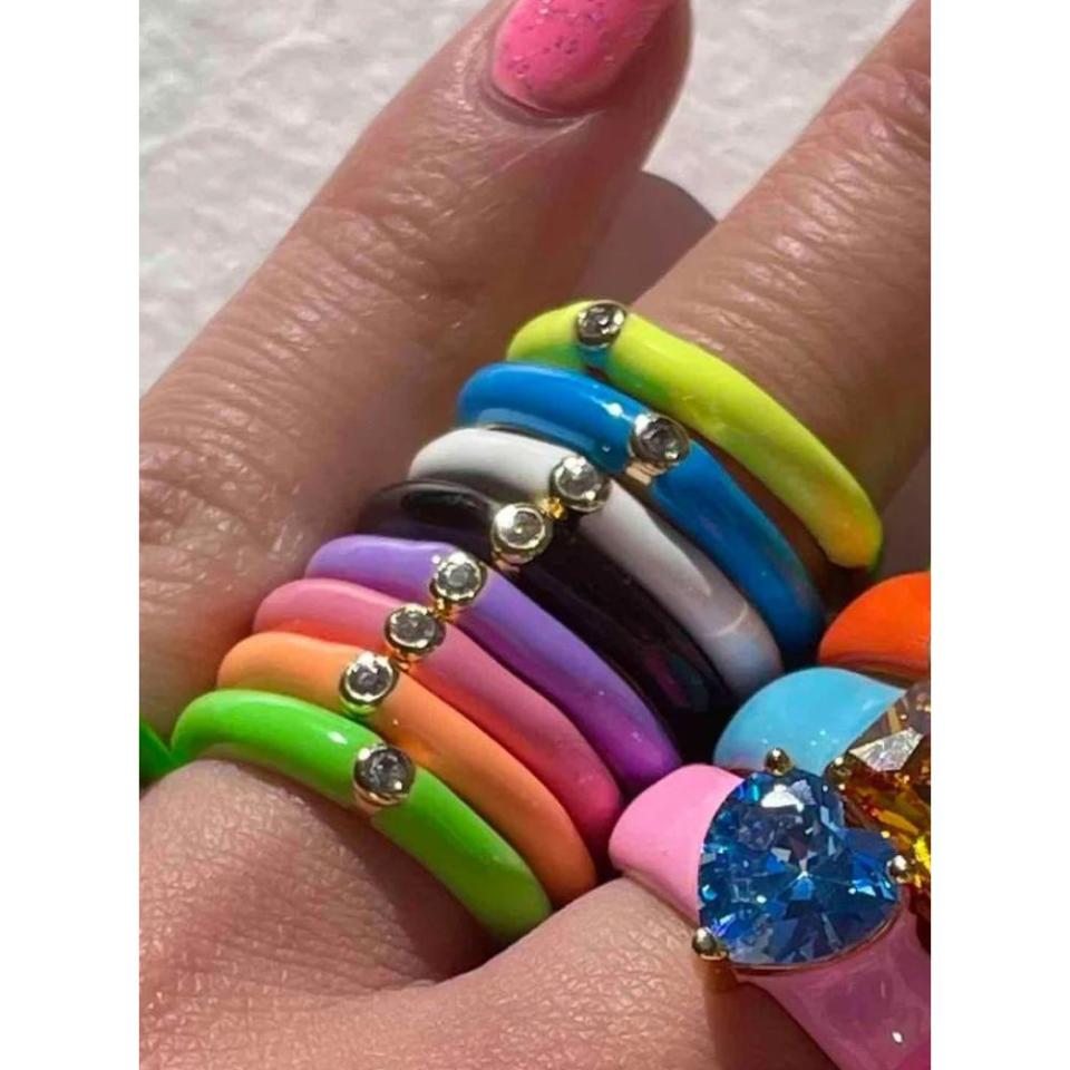 model wearing eight neon colored stacking rings