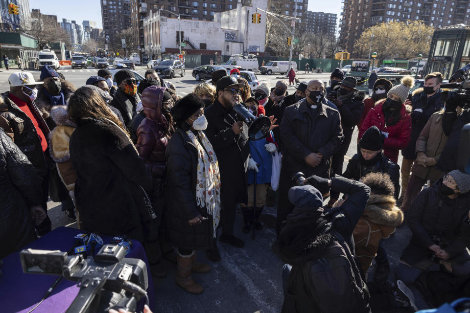 People gather for a news conference organized by the National Action Network near the scene of a shooting the day before in the Harlem neighborhood of New York, Saturday, Jan. 22, 2022. (AP Photo/Yuki Iwamura)