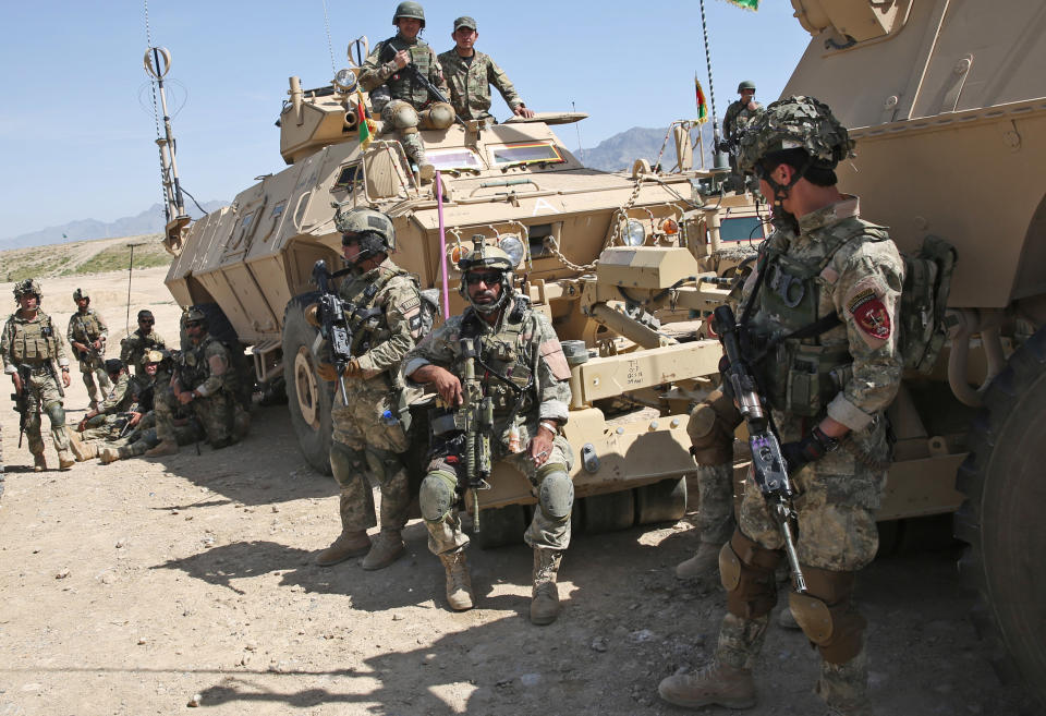 Afghan National Army (ANA) soldiers prepare to participate in a military exercise on the outskirts of Kabul, Afghanistan, Wednesday, April 30, 2014. The Afghan National Security Forces depend exclusively on billions of dollars in funding from the United States and its allies, money that is now at risk. (AP Photo/Massoud Hossaini)