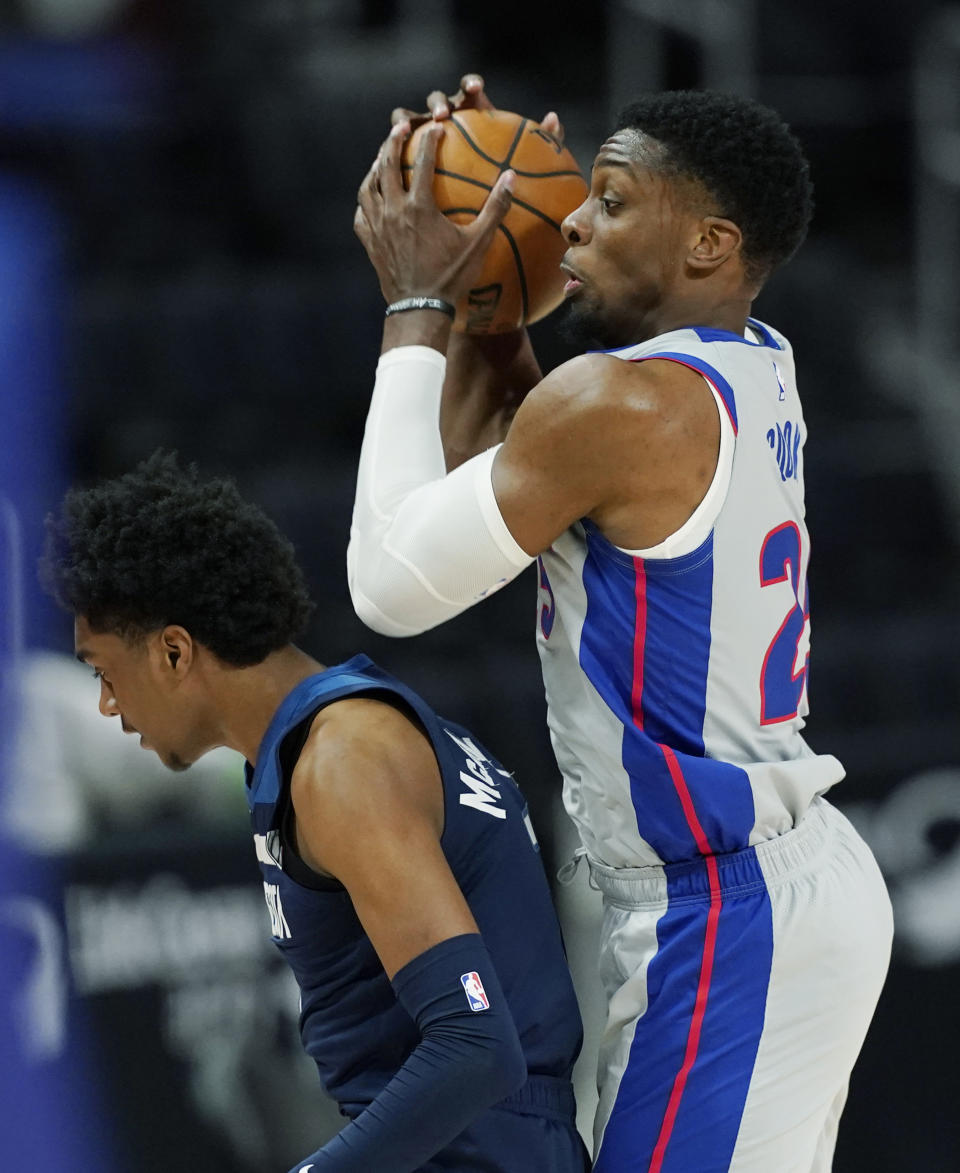 Detroit Pistons forward Tyler Cook controls the ball behind Minnesota Timberwolves guard Jordan McLaughlin during the second half of an NBA basketball game, Tuesday, May 11, 2021, in Detroit. (AP Photo/Carlos Osorio)