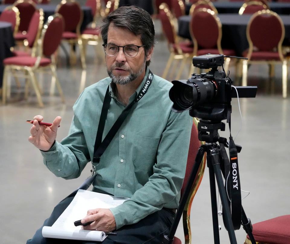 Milwaukee Journal Sentinel reporter John Diedrich interviews Michael Sodini, a former gun importer who started Walk the Talk America to discuss mental health concerns among gun owners, at a gun show in Milwaukee in September 2023.