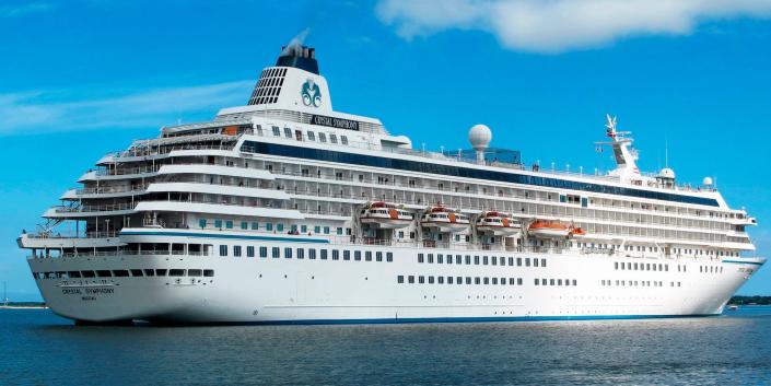 A cruise ship, the Crystal Symphony, at sea with a blue sky behind it in 2013.