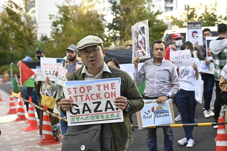 Protestors hold banners to protest Israeli airstrikes in Gaza Strip as hundreds of people gather near the Israel embassy in Tokyo, Japan on Oct. 21. (Photo by David Mareuil/Anadolu via Getty Images)