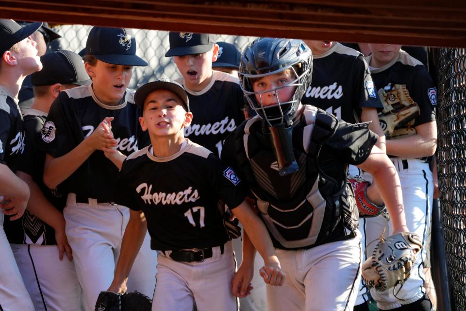 East Hanover celebrates before going into the dugout after they say Holbrook Little League down, 1-2-3, in the third inning. Sunday, July 30, 2023
