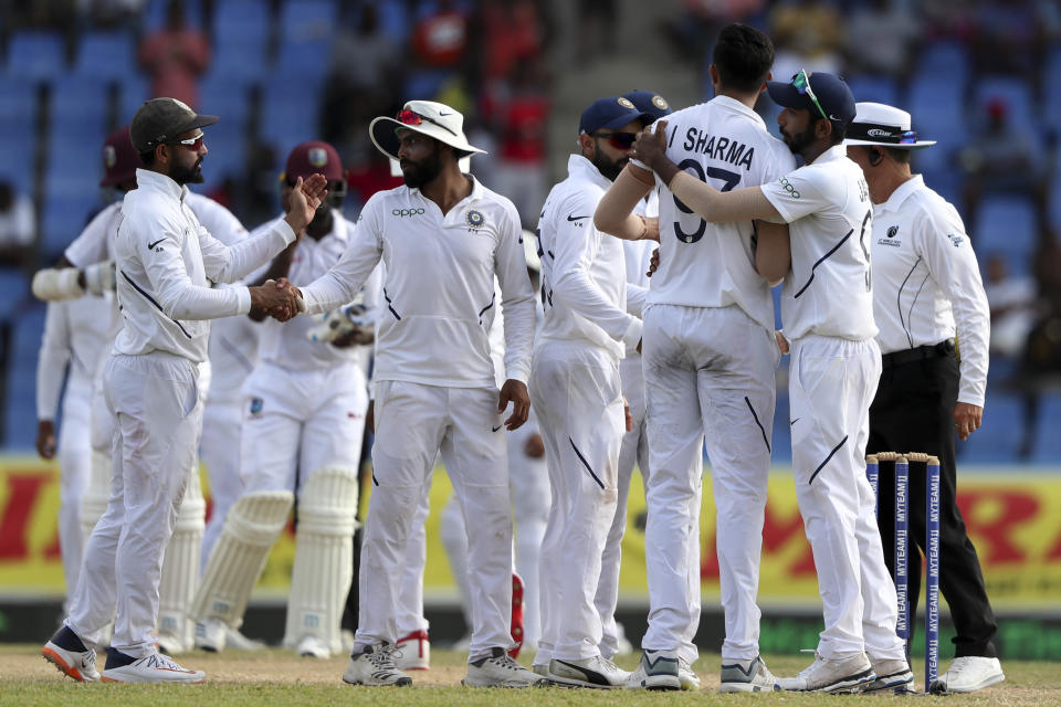 Players of India celebrate beating West Indies by 318 runs at the end of day four of the first Test cricket match at the Sir Vivian Richards cricket ground in North Sound, Antigua and Barbuda, Sunday, Aug. 25, 2019. (AP Photo/Ricardo Mazalan)