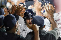 New York Yankees' Joey Gallo is congratulated by teammates after his three-run home run during the seventh inning of the team's baseball game against the Seattle Mariners, Thursday, Aug. 5, 2021, in New York. (AP Photo/Mary Altaffer)