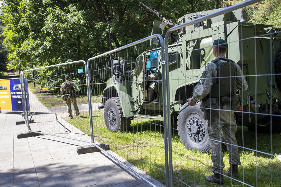 Soldiers stand guard at a fence surrounding the venue of the NATO summit in Vilnius, Lithuania, Sunday, July 9, 2023. Russia's war on Ukraine will top the agenda when U.S. President Joe Biden and his NATO counterparts meet in the Lithuanian capital Vilnius on Tuesday and Wednesday. (AP Photo/Mindaugas Kulbis)