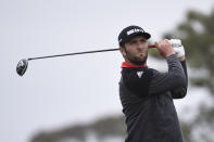 Jon Rahm, of Spain, hits his tee shot on the fifth hole of the South Course at Torrey Pines Golf Course during the final round of the Farmers Insurance golf tournament Sunday, Jan. 26, 2020, in San Diego. (AP Photo/Denis Poroy)