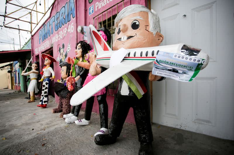 FILE PHOTO: A pinata of Mexico's President Andres Manuel Lopez Obrador holding a scale model of the presidential plane and mock lottery tickets for its raffle, is pictured outside the workshop of artisan Dalton Ramirez in Reynosa