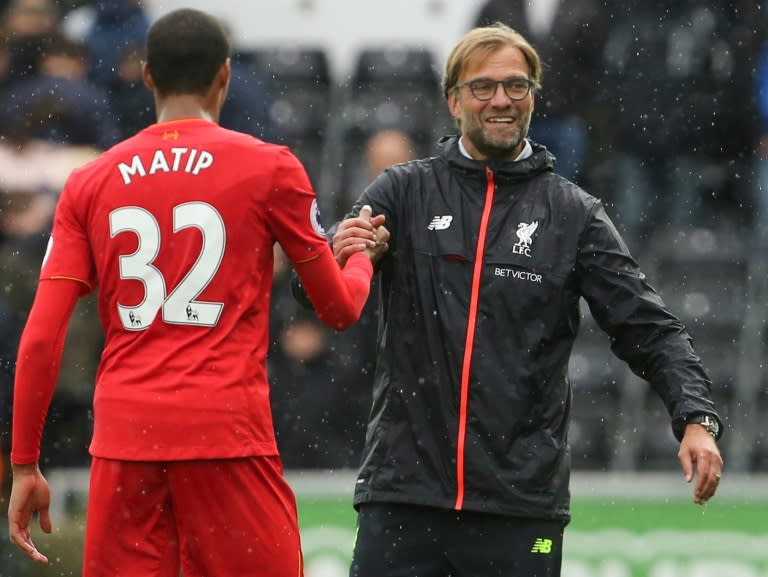 Liverpool's manager Jurgen Klopp (R) congratulates defender Joel Matip at the end of their English Premier League match against Swansea City, at The Liberty Stadium in Swansea, south Wales, on October 1, 2016