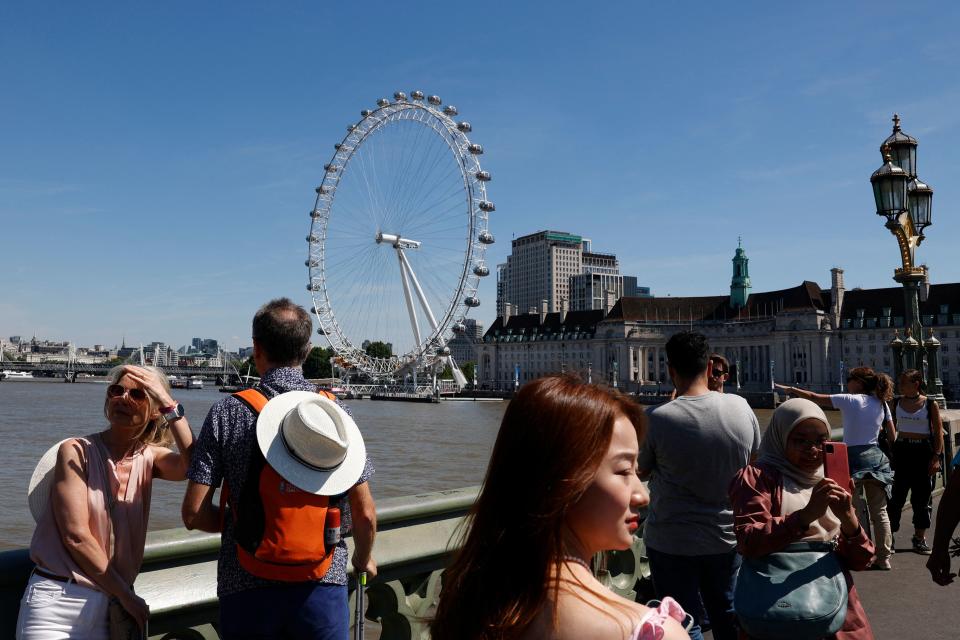 People cross the Westminster bridge in London on July 11, 2022 on what is expected to be one of the hottest days of the year so far in the capital. (Photo by CARLOS JASSO / AFP) (Photo by CARLOS JASSO/AFP via Getty Images)