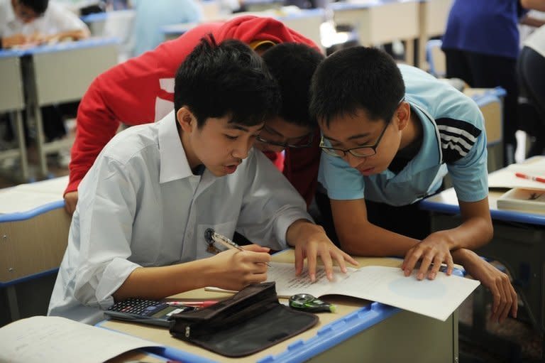 Boys solve a maths problem at the government-run Number Eight High School in Shanghai, on October 15, 2012. Teenage boys at the school are on the front line of teaching reform after the world's top-scoring education system introduced male-only classes over worries they are lagging girls