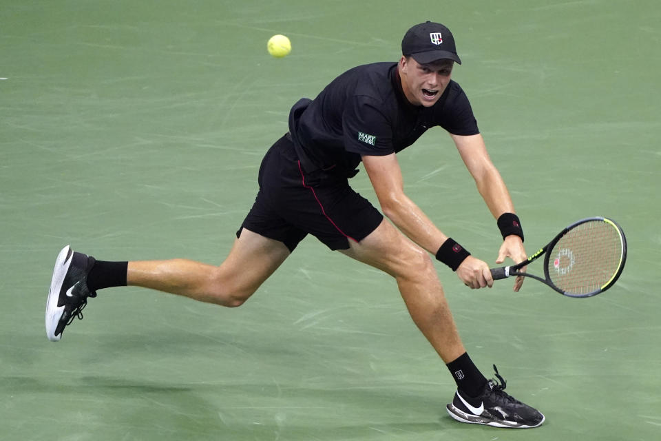 Jenson Brooksby, of the United States, returns against Novak Djokovic, of Serbia, during the fourth round of the U.S. Open tennis championships, Monday, Sept. 6, 2021, in New York. (AP Photo/John Minchillo)