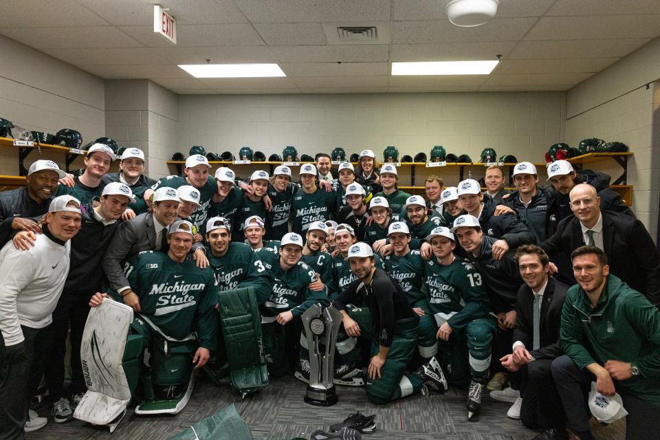 The Michigan State hockey team poses with the 2023-2024 Big Ten regular-season trophy following its 5-2 win over No. 4 Wisconsin on March 1, 2024 at the Kohl Center in Madison, Wis.