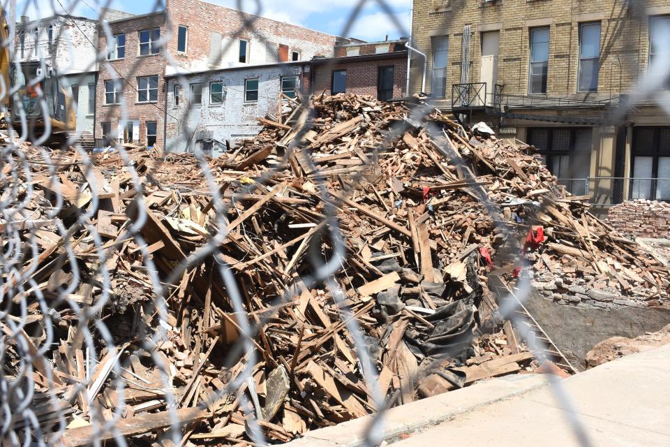 Piles of debris and rubble from three buildings along South Main Street in downtown Adrian that were recently demolished are pictured Wednesday.