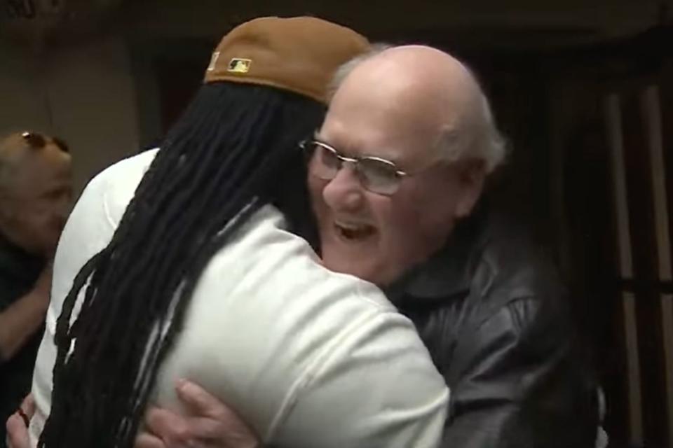<p>WCVB Channel 5 Boston</p> Umar Fox hugs retired firefighter Joseph Gilmore, who saved him in 1978.