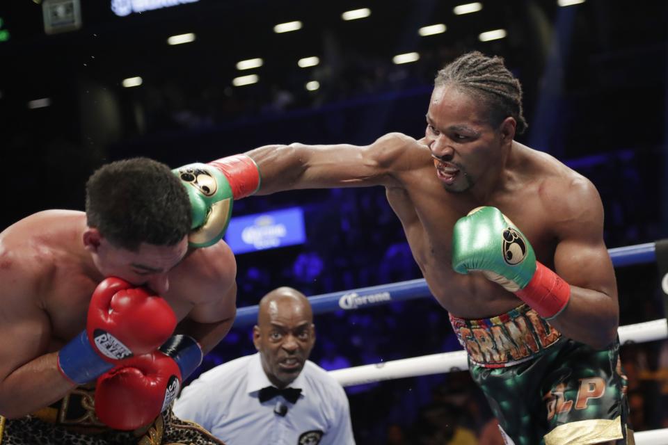 FILE - In this Sept. 8, 2018, file photo, Shawn Porter, right, punches Danny Garcia during the eighth round of a WBC welterweight championship boxing match in New York. Shawn Porter needed a place to train, and someone to fight. His father, Kenny, gave him both during the pandemic lockdown. (AP Photo/Frank Franklin II, File)