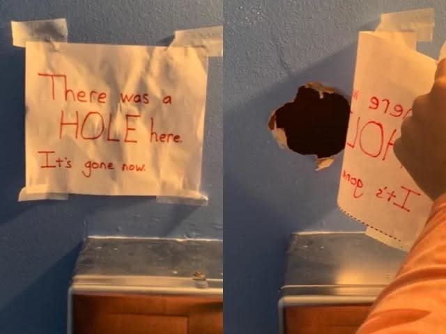 Handwritten sign "There was a hole here; it's gone now" on a wall above a sink