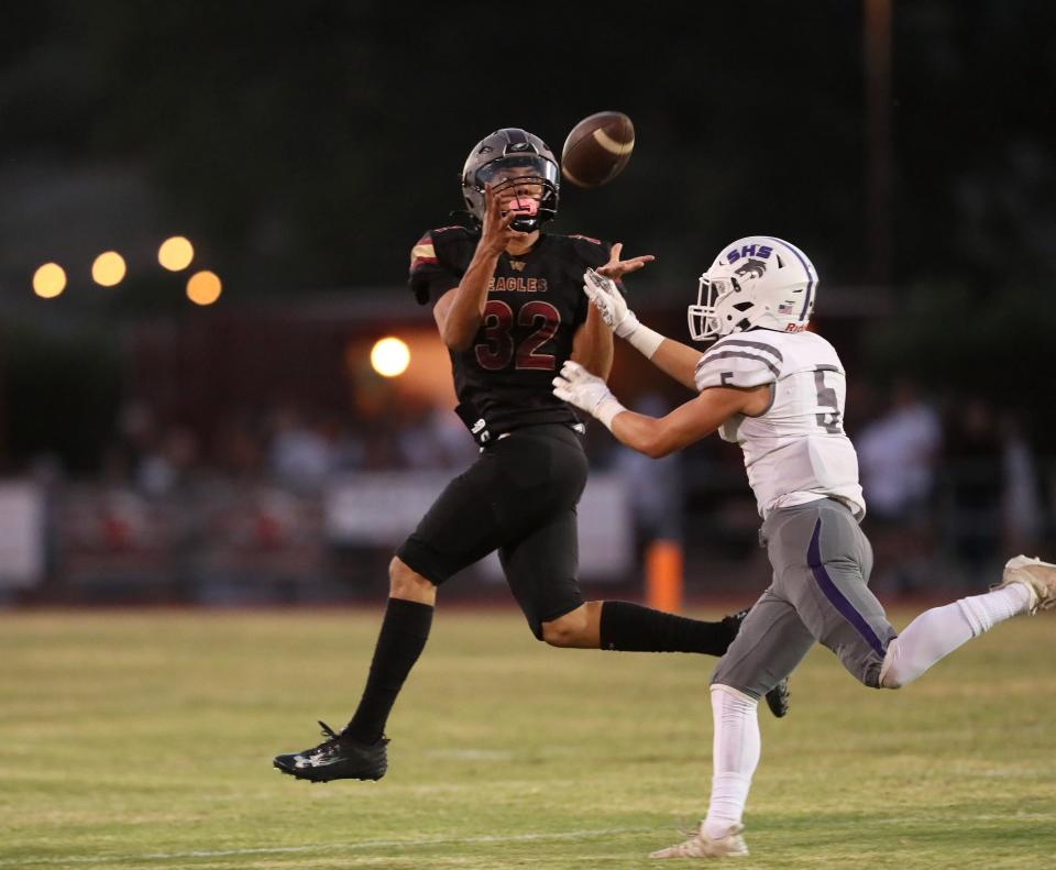 West Valley's Jesus Cervantes (left) receives the ball as he run down the end zone against Shasta's Joe Beasley (right) in the 1st quarter at the Pasture on Friday, Sept. 8, 2023.
