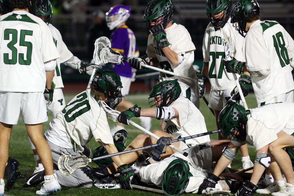 Yorktown players celebrate their 8-7 overtime victory against John Jay at Yorktown High School April 4, 2024.