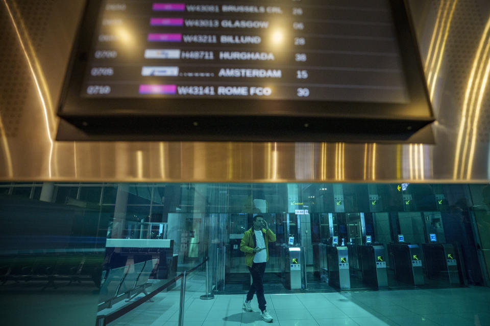 A journalist passes Non-Schengen automatic border control gates during a media tour at the Henri Coanda International Airport in Otopeni, near Bucharest, Romania, Sunday, March 31, 2024. Romania and Bulgaria joined Europe's passport- and visa-free Schengen Area, applying only to travelers arriving by air and sea. (AP Photo/Andreea Alexandru)