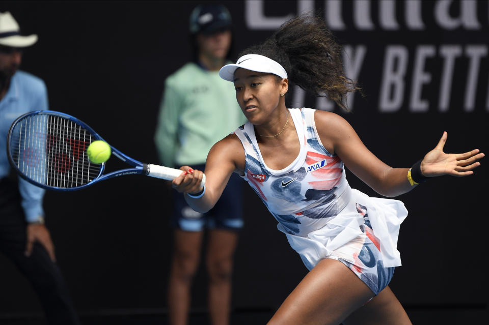 Japan's Naomi Osaka makes a forehand return to China's Zheng Saisai during their second round singles match at the Australian Open tennis championship in Melbourne, Australia, Wednesday, Jan. 22, 2020. (AP Photo/Andy Brownbill)