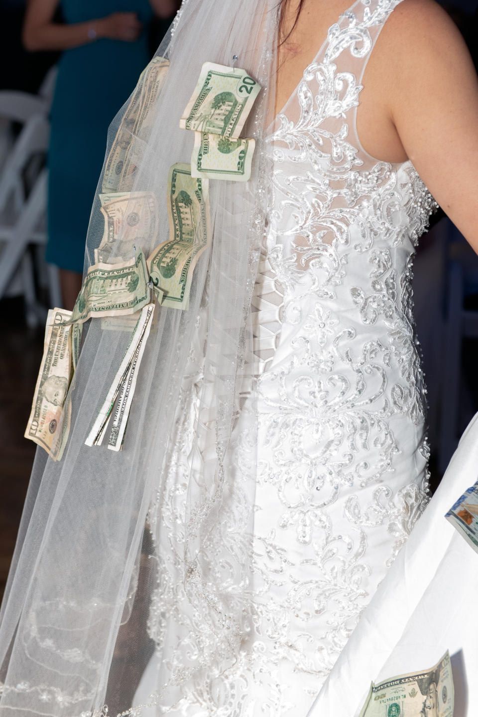 Money pinned on a bride's veil