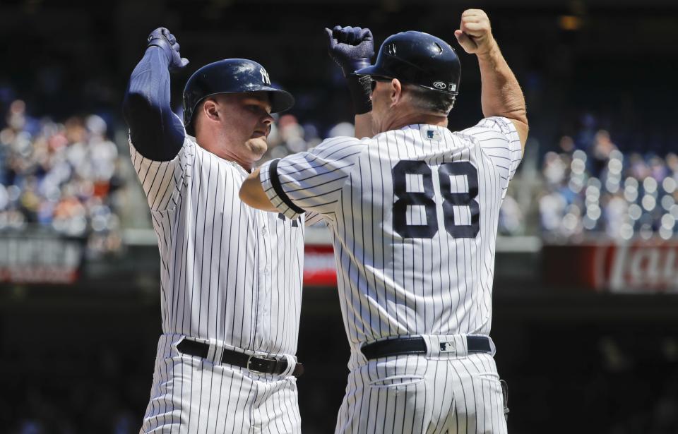 New York Yankees' Luke Voit, left, celebrates with third base coach Phil Nevin as he runs the bases after hitting a three run home run during the fourth inning against the New York Mets in the first baseball game of a doubleheader, Tuesday, June 11, 2019, in New York. (AP Photo/Frank Franklin II)