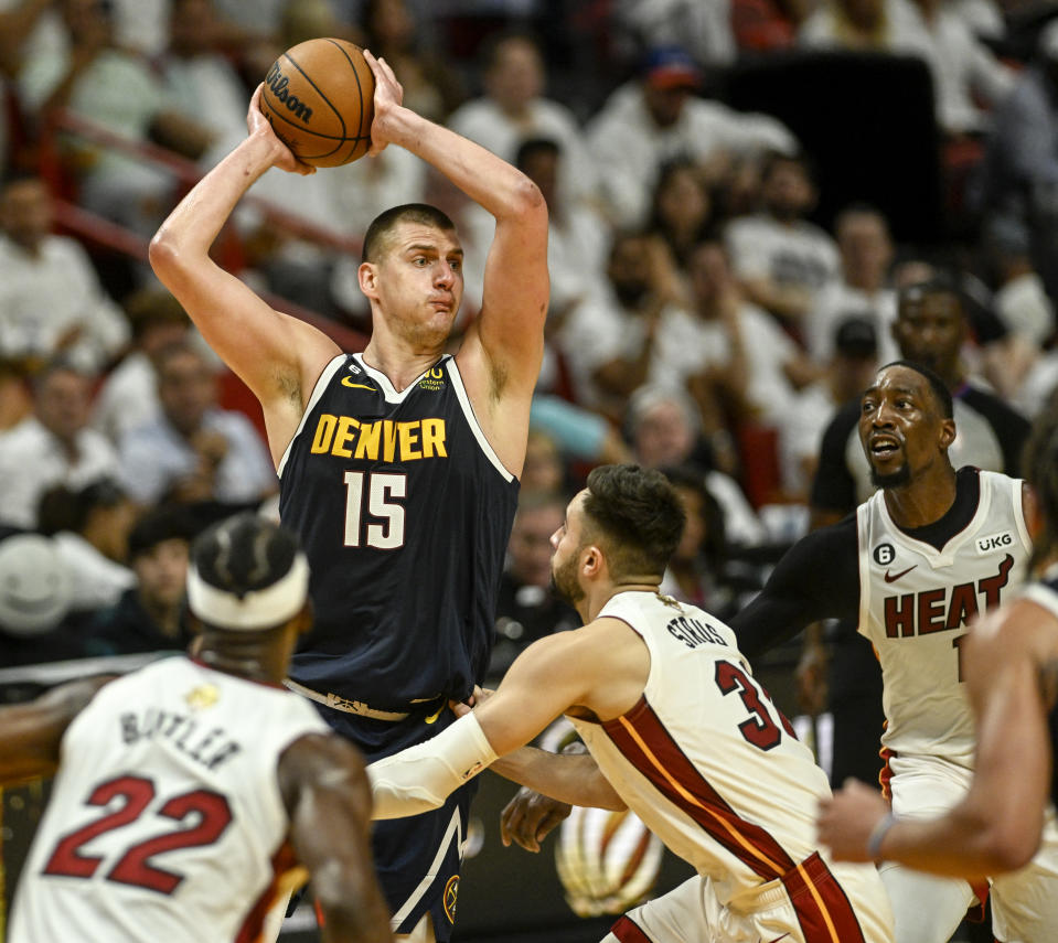 MIAMI, FL - JUNE 9: Nikola Jokic (15) of the Denver Nuggets works as Jimmy Butler (22), Max Strus (31) and Bam Adebayo (13) of the Miami Heat defend in the first half of the Nuggets' 108-95 win during Game 4 of the NBA Finals at the Kaseya Center in Miami on Friday, June 9, 2023. (Photo by AAron Ontiveroz/The Denver Post)