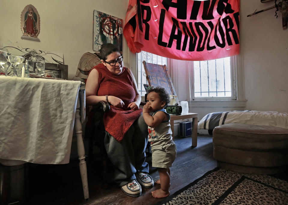 In this Friday, Feb. 17, 2017 photo, Franki Velez looks at her son Ashoka Little, 1, in their home in Oakland, Calif. An Iraq War veteran who says she is on disability for Post Traumatic Stress Disorder, Velez is a full-time activist who is simultaneously cheered by and worried about the post-Trump infusion of more traditional liberals eager to protest. "I see a lot of liberal people talking about reforming the system," said Velez, whose parents are Puerto Rican and whose mother's family was shipped to Hawaii to work on sugar plantations. "They don't understand it's a colonial system that's never meant to be reformed." (AP Photo/Ben Margot)