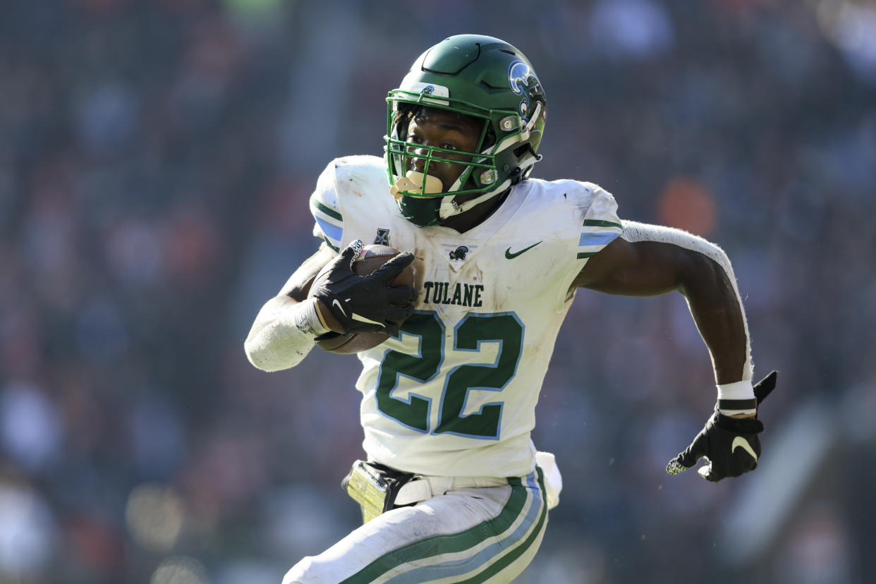 Tulane running back Tyjae Spears (22) carries the ball for a touchdown against Cincinnati, Friday, Nov. 25, 2022, in Cincinnati. Tulane won 27-24. (AP Photo/Aaron Doster)