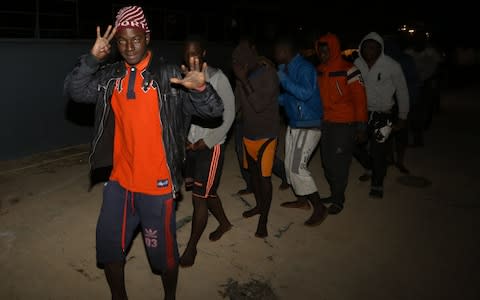 Migrants arrive at a naval base in Tripoli late on January 31, 2018, after they were rescued off Libya's coast.  - Credit: AFP