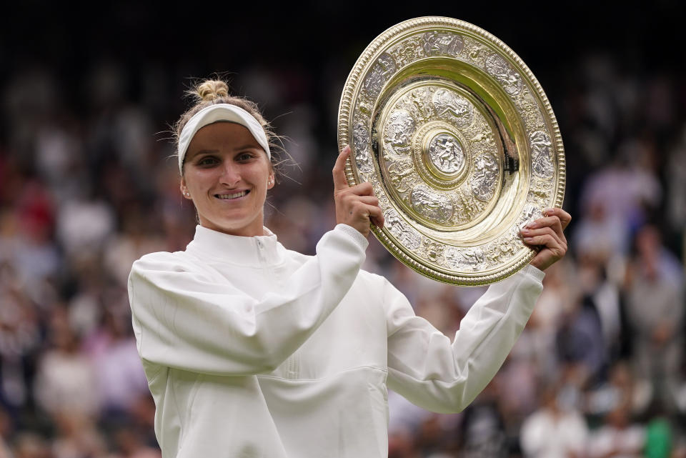 FILE - Czech Republic's Marketa Vondrousova celebrates with the trophy after beating Tunisia's Ons Jabeur to win the final of the women's singles on day thirteen of the Wimbledon tennis championships in London, Saturday, July 15, 2023. Vondrousova won her first Grand Slam title at Wimbledon last year and was the 2019 runner-up at the French Open, which starts Sunday at Roland Garros in Paris. (AP Photo/Alberto Pezzali, File)