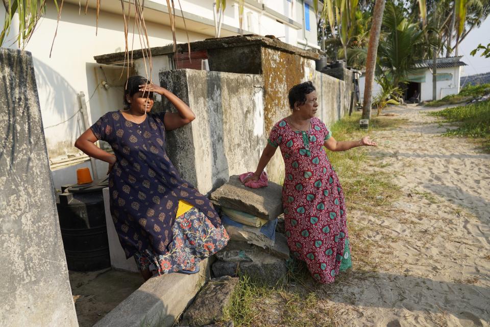 Hima Rose, left, and neighbor Reetha Maria, talk in Kochi, Kerala state, India, on March 4, 2023, about their experience during Cyclone Tauktae in 2021. "I was shocked to see waves carrying huge granite stones of the old sea wall and tons of water gushing directly to my home," Maria said. "You may have no idea how many days that we took to clean the stinking mud and filth brought by the seawater." (AP Photo)