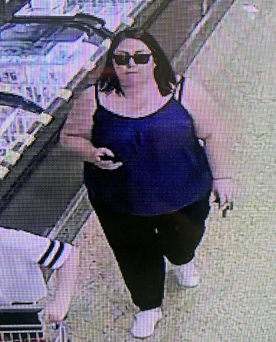 The suspect is a dark-haired woman wearing sunglasses and a sleeveless blue top. (Picture: SWNS)