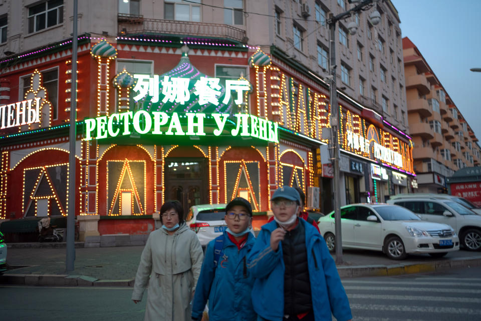 People cross the road outside a mall emblazoned with Russian and Chinese inscriptions in the city of Heihe in northern China last month. (Fred Dufour / NBC News)