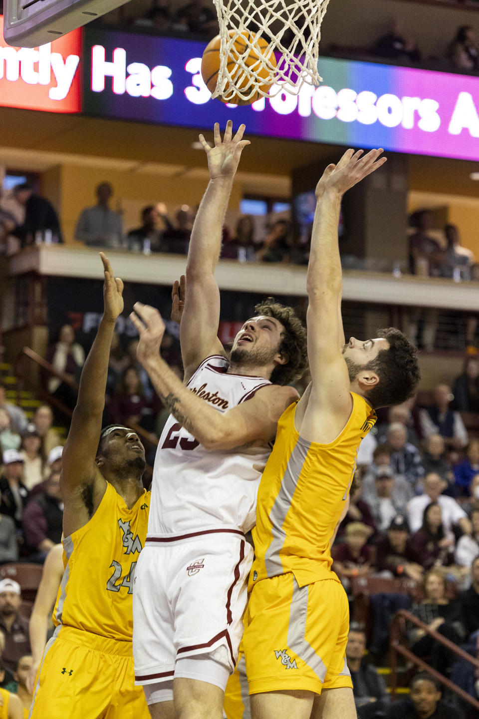 Charleston's Ben Burnham (25) shoots between two defenders from William & Mary in the first half of an NCAA college basketball game in Charleston, S.C., Monday, Jan. 16, 2023. (AP Photo/Mic Smith)