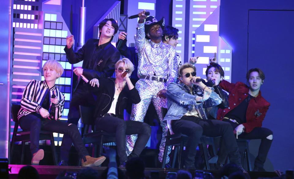 FILE - Lil Nas X, background center, performs "Old Town Road" with members of the Korean pop band BTS at the 62nd annual Grammy Awards in Los Angeles on Jan. 26, 2020. “Dynamite,” the group’s first all-English song, debuted at No. 1 on the U.S. music charts this week, making BTS first Korean pop act to top the chart. (Photo by Matt Sayles/Invision/AP, File)