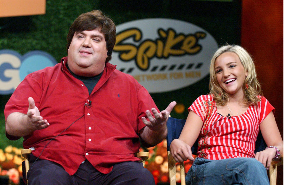 Dan Schneider sitting on stage next to JamieLynn Spears