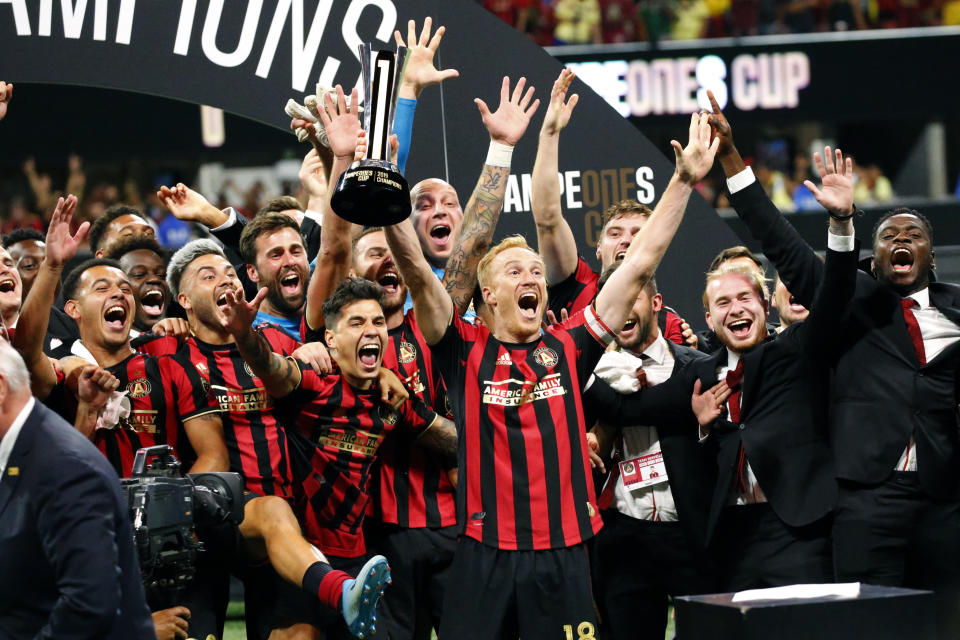 Atlanta United players celebrates with the trophy after defeating Club America 3-2 in the Campeones Cup soccer final Wednesday, Aug. 14, 2019, in Atlanta. Atlanta United, which had wrapped up a dismal 2020 MLS season on Nov. 8, returned to the pitch 5 1/2 weeks later to play one more game: the second leg of a quarterfinal series against Mexico's Club América. And when was the first leg played? Way back on March 11, just as the coronavirus was bringing everything to a screeching halt. (AP Photo/John Bazemore)