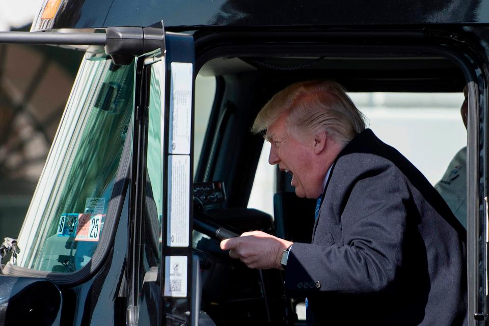 President Donald Trump sits in the drivers seat of a truck as he welcomes truckers and CEOs to the White House in Washington, DC, on March 23, 2017.