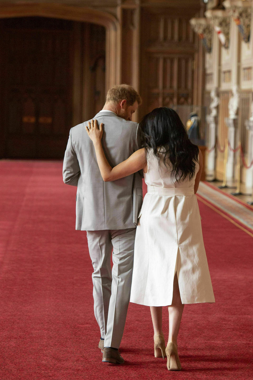 FILE - In this Wednesday May 8, 2019 file photo Britain's Prince Harry and Meghan, Duchess of Sussex, leave after a photo call with their newborn son, in St George's Hall at Windsor Castle, Windsor, south England. Prince Harry and Meghan Markle are to no longer use their HRH titles and will repay £2.4 million of taxpayer's money spent on renovating their Berkshire home, Buckingham Palace announced Saturday, Jan. 18. 2020. (Dominic Lipinski/Pool via AP, File)