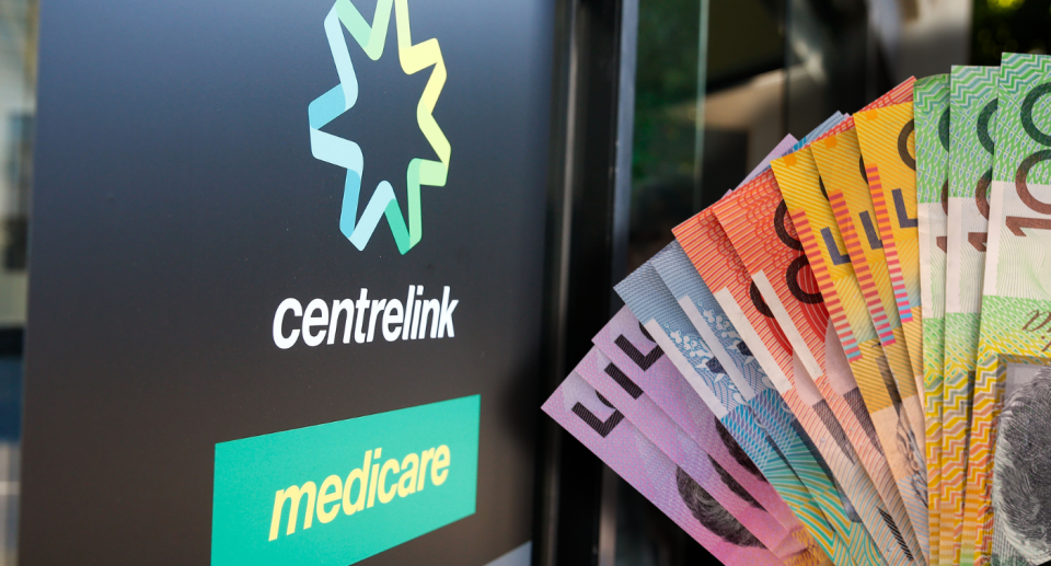 Centrelink sign next to wad of Australian money