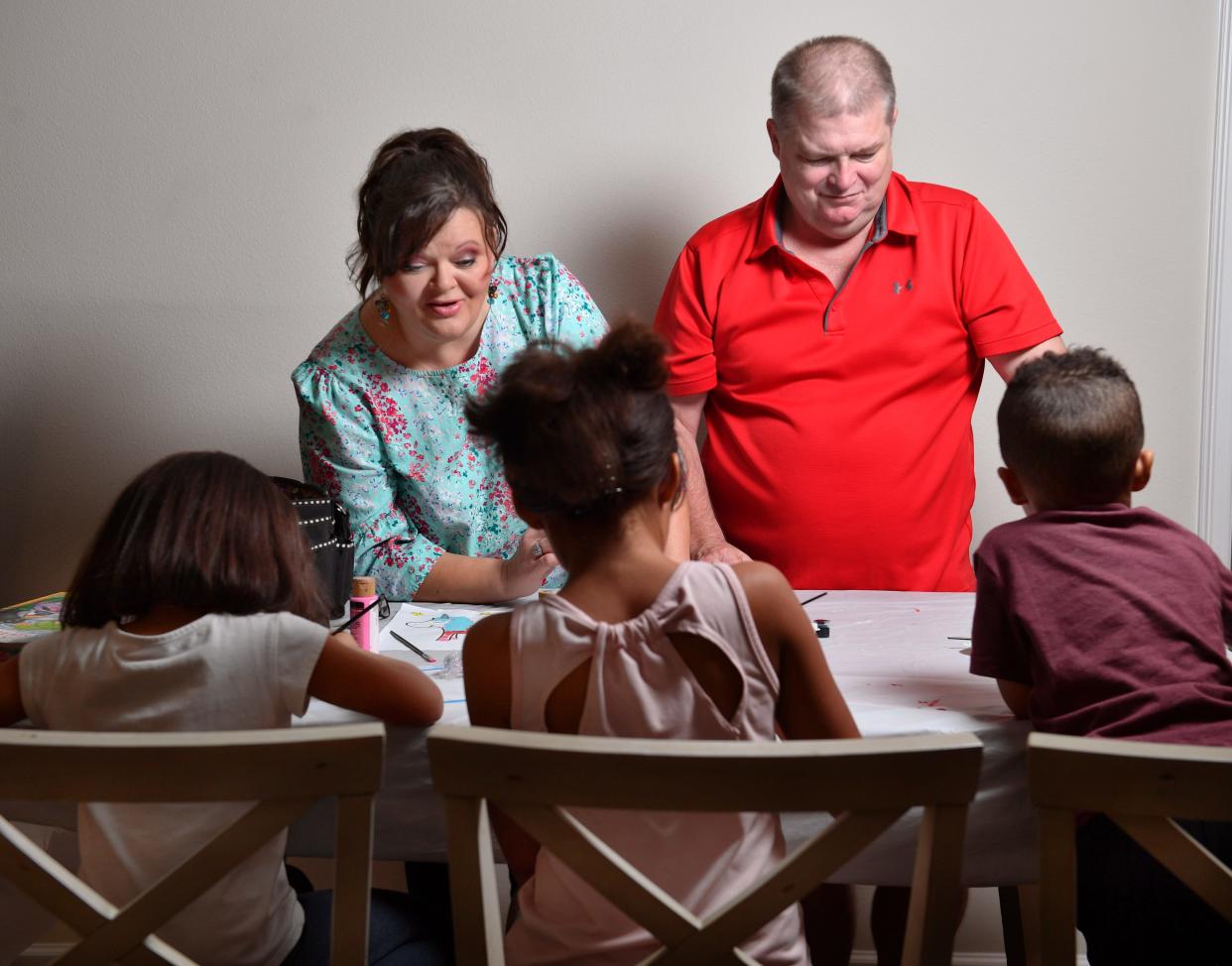 Angie and Marvin Gore help their grandchildren with painting at the dining room table. The children, who we aren't naming are ages, from left, 5, 9 and 3. Angie missed three weeks of work due to COVID, causing them to fall behind on rent.