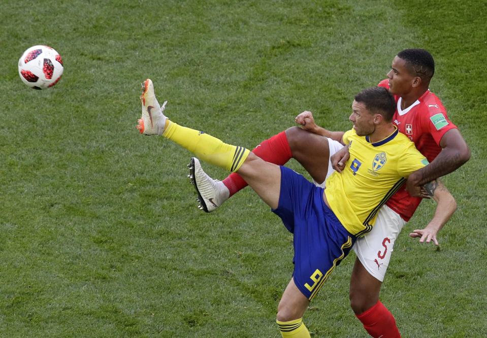 <p>Sweden’s Marcus Berg, left, duels for the ball with Switzerland’s Manuel Akanji during the round of 16 match between Switzerland and Sweden at the 2018 soccer World Cup in the St. Petersburg Stadium, in St. Petersburg, Russia, Tuesday, July 3, 2018. (AP Photo/Dmitri Lovetsky) </p>