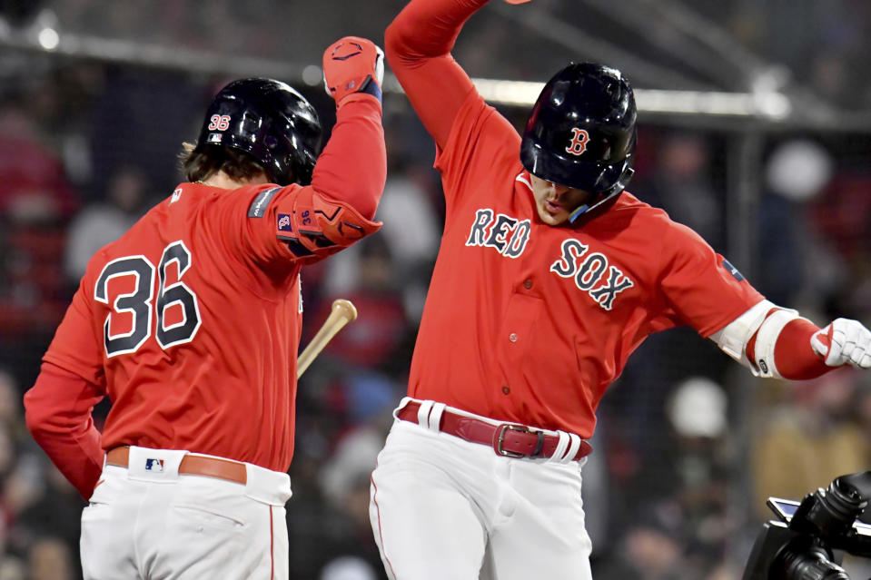 Boston Red Sox's Enrique Hernandez, right, celebrates his home run with Triston Casas (36) during the sixth inning of the team's baseball game against the Minnesota Twins at Fenway Park, Wednesday, April 19, 2023, in Boston. (AP Photo/Mark Stockwell)