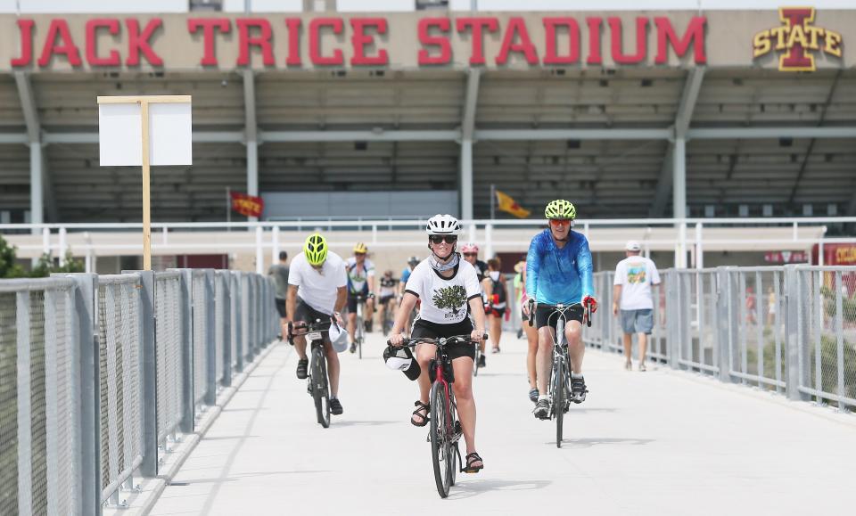 RAGBRAI riders cross the bridge at Jack Trice Stadium to finish day 3 of the ride on Tuesday, July 25, 2023, in Ames, Iowa.