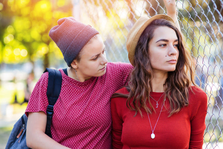 Woman looking concerned at her partner, who is looking away