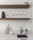 <p> &apos;It can be very tempting to overcrowd and fill a shelf with an abundance of items, and in many spaces, this maximalist look can work wonderfully, however, styling a shelf with minimalism in mind allows for key decorative pieces to be fully appreciated - and is also a great option for smaller spaces,&apos; says Jennifer Ebert,&#xA0;<em>Homes &amp; Gardens</em>&apos; Digital Editor. </p> <p> In this kitchen, designed by Kimberley Harrison Interiors, the warming wooden shelves have been elegantly decorated with glassware and a few select ornaments. The result creates a calming, spacious display where every item can be easily viewed and taken off the shelf if needed. </p>
