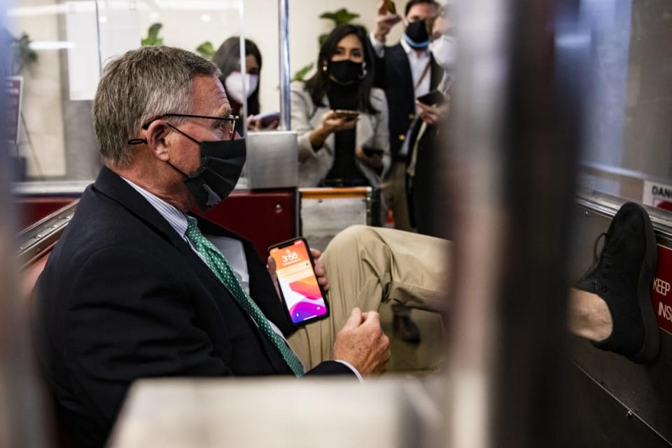 <div class="inline-image__caption"><p>Sen. Richard Burr boards a train after voting to convict Donald Trump.</p></div> <div class="inline-image__credit">Samuel Corum/Getty</div>